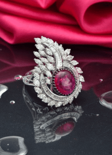 Silver ring with ruby stone on pink silk – jewellery photography