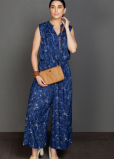 Woman in blue printed jumpsuit with clutch – ecommerce womenswear photography
