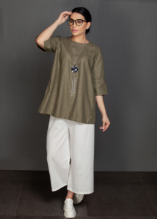 Woman in olive top and white culottes – ecommerce womenswear photography