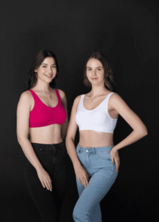 Two models in pink and white sports bras with jeans – lingerie photoshoot