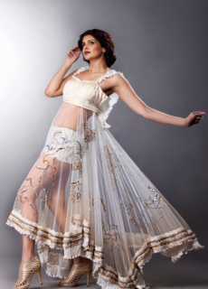 Model in sheer embellished lehenga, dramatic pose – bridal fashion shoot