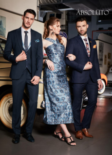 Models in suits and printed dress beside a vintage car – fashion brand campaign