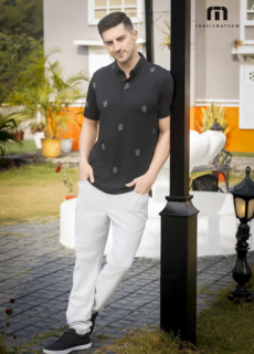 Male model in black shirt and white trousers outdoors – menswear lookbook