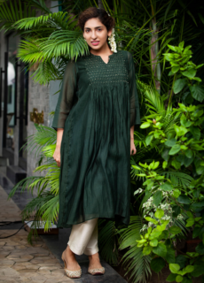 Woman in dark green kurta in a garden – ethnic wear photoshoot