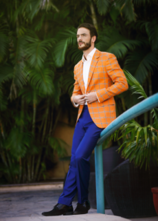 Male model in orange blazer on outdoor steps – menswear fashion shoot