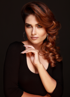 Woman in black top with curled hair – fashion portrait
