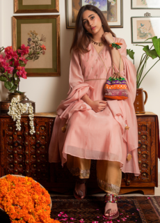 Woman in peach ethnic suit in a vintage living room – ethnic wear shoot