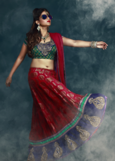 Model in red lehenga and green blouse twirling – ethnic fashion editorial