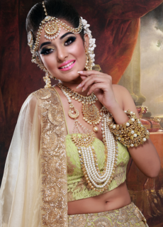 Bride in gold jewellery and green lehenga – bridal beauty photoshoot