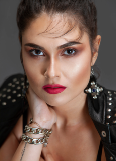 Close-up beauty portrait of model with red lipstick and statement ring