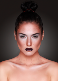 Model with bold dark lipstick and slicked bun – beauty portrait