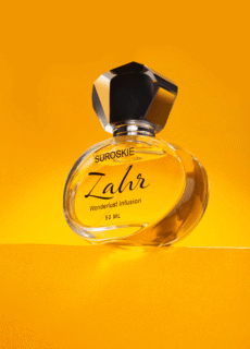 Zahr perfume bottle on yellow backdrop – product photography