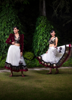 Two models in black and white ethnic outfits at night – fashion editorial