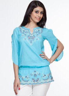 Woman in turquoise embroidered top – ecommerce womenswear photography